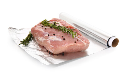 Aluminium foil roll with piece of raw meat, rosemary and peppercorns on white background