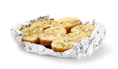 Raw potato with spices wrapped in aluminium foil on white background