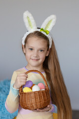 Happy easter! Portrait of funny happy laughing child girl with easter eggs and bunny ears on white background. funny wow face.