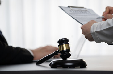 Focus gavel hammer for righteous and equality judgment with blur background of lawyer colleagues or...