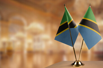 Small flags of the Tanzania on an abstract blurry background