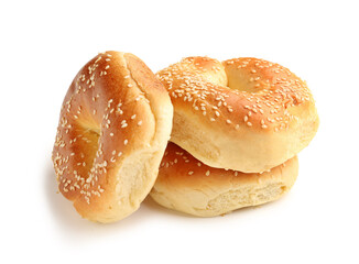 Tasty bagels with sesame seeds on white background
