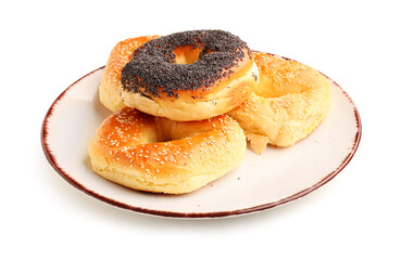 Plate of tasty bagels on white background
