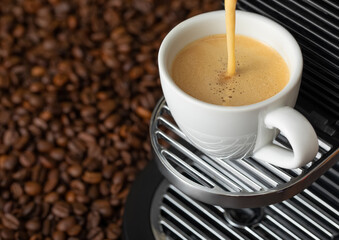 Pouring fresh morning coffee with espresso machine and sunlight and raw aroma beans.