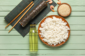 Set of ingredients for preparing tasty sushi rolls on color wooden background