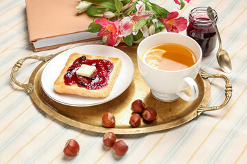 Fototapeta na wymiar Tasty toast with jam and cup of tea on table