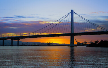 Fototapeta na wymiar Eastern span of San-Francisco-Oakland Bay Bridge view at sunrise. Shot from Treasure Island, San Francisco, California, USA.