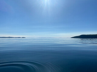 Beautiful Lake Superior in Thunder Bay Ontario during the daytime with Blue water and mountains in the background
