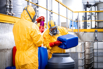 Factory workers mixing chemicals and manufacturing sulfuric acid.
