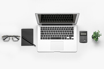 Composition with laptop, eyeglasses and calculator on white background