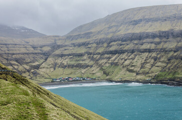 Tjornuvik, fishing village in Streymoy, Faroe Islands, Northern Europe, waves on the sea during the rainy day