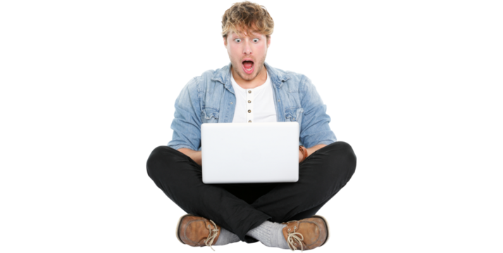 Laptop computer man shocked looking surprised at screen. Young modern male student model sitting cross legged on floor isolated on transparent PNG background. - Powered by Adobe