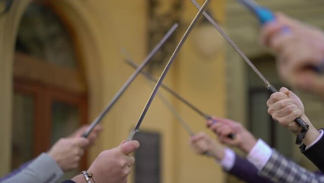 People with sabers, sword strikes. The sound of swords. Tradition on holiday.