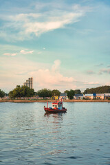 Obraz premium Wooden fishing trawler boat on tropical sea in the evening