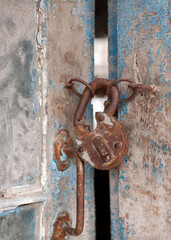 Old rusty lock on a wooden door