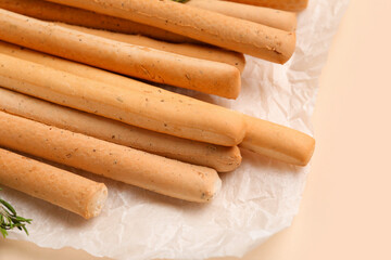 Tasty Italian Grissini on yellow background, closeup