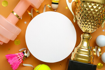 Blank card with gold cup, sports equipment and confetti on orange background