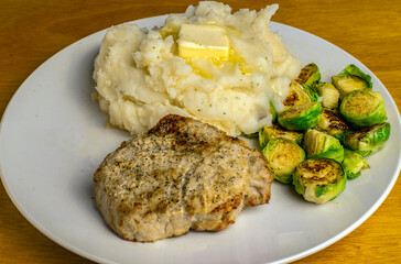 pork chop with roasted brussel sprouts and mashed potatoes
