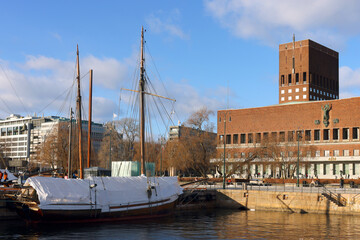 Oslo Harbour and Radhuset building, Oslo City Hall. Promenade along the seafront Old Port Oslo. View of the shore of Oslofjord, Norway