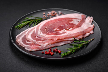Fresh raw bacon sliced with spices and herbs