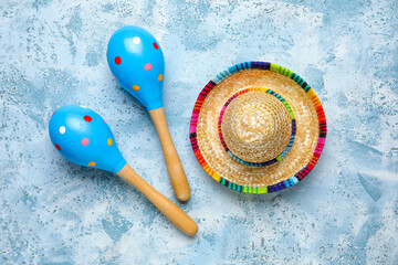 Mexican maracas with sombrero hat on grunge background