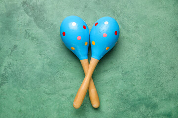 Mexican maracas on green background