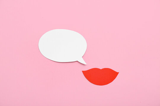 Paper lips with speech bubble on pink background. Dialogue concept