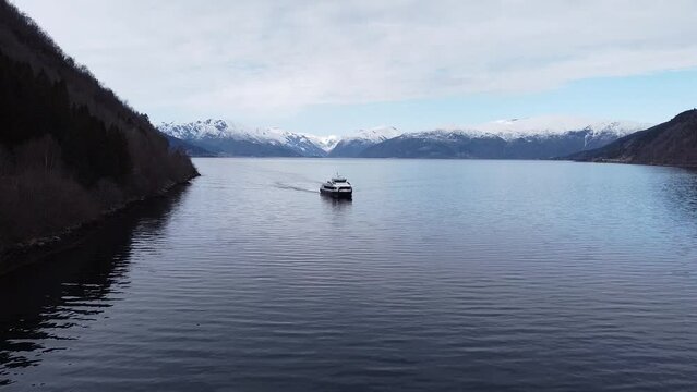 Aerial still shot of ferry driving in Sognefjorden closing in on Vik&oslash;yri