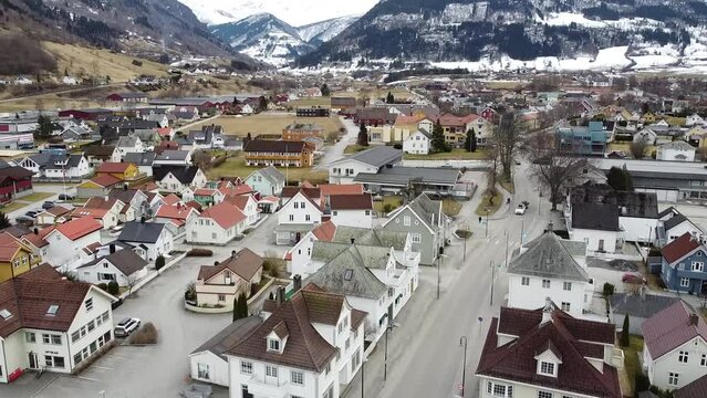 Aerial pedestal shot of Vik&oslash;yri, with cars driving by on the main road.