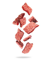 Dried pieces of beef in the air on a white background