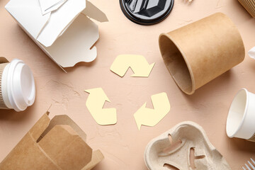 Recycling sign with garbage on beige background