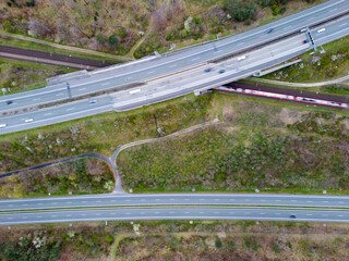 Aerial top down view of highways and train tracks with the traffic