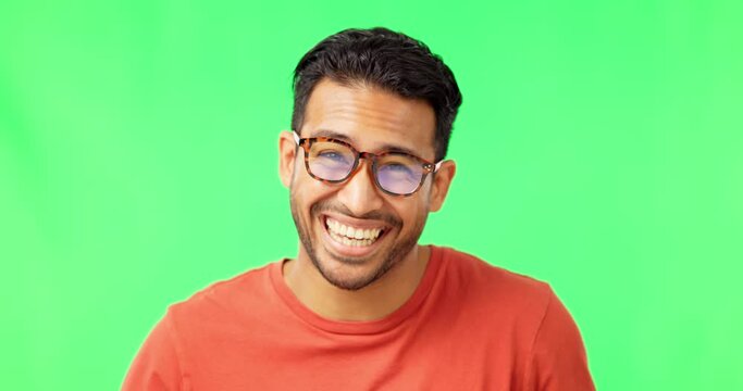 Funny, glasses and an Asian man laughing on a green screen isolated on a studio background. Silly, happy and a face portrait of a guy playing with eyewear, being comic and goofy on a backdrop
