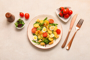 Composition with tasty potato salad with eggs and tomatoes on light background