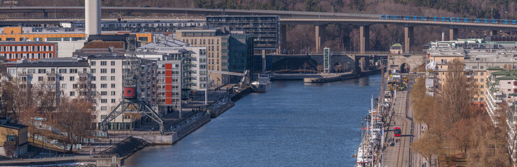The pier Hammarby kaj, apartment houses a port mill, a sunny spring day in Stockholm
