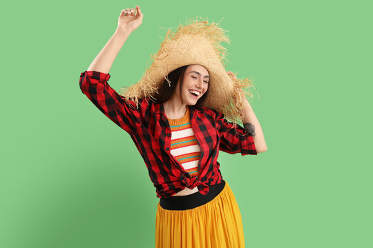 Young woman dancing on green background. Festa Junina (June Festival) celebration