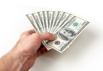 Pile of one hundred dollars banknotes  in male hands on white background close up - 590900721