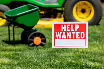 Help wanted sign for lawn care and mowing work. Labor shortage, trade jobs market and employment...