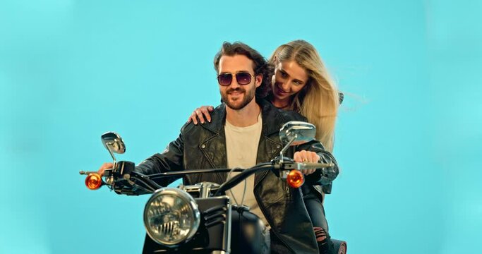Selfie, blue background and couple on motorcycle with phone for adventure, road trip and holiday mockup. Motorbike, transport and man and woman take picture for social media, post or memory in studio