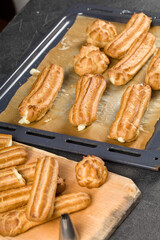 Filling freshly baked eclairs with custard