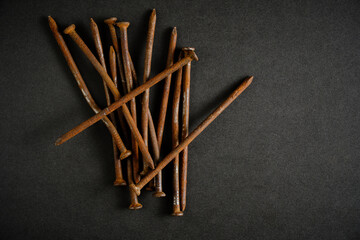 Old rusty nails black background.