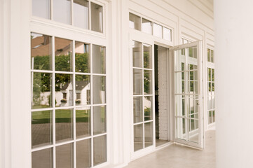 Fototapeta na wymiar White large panoramic windows with sprats in the house