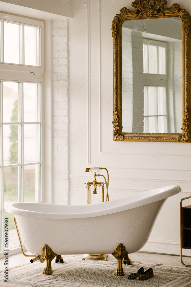 Wall mural free-standing bathtub near the window with gold faucets and vintage mirror