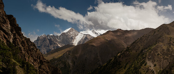 A panoramic view of the massive mountain peak of the Turkestan Mountains.