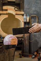 Hand blown glass art being made in hotshop studio