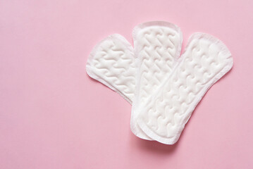 Feminine sanitary pad pattern on pink background. Hygiene care during critical days, caring for women's health. Daily and monthly protection. Copy space. menstrual cycle.