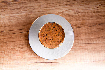 cup of coffee on wooden table