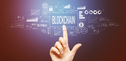 Blockchain theme with hand pressing a button on a technology screen