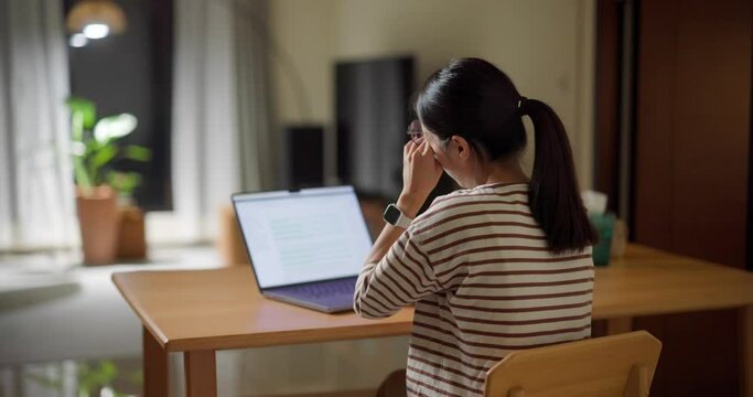 Woman work on laptop computer and feel dry of the eye at home