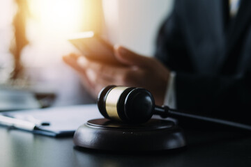 Business and lawyers discussing contract papers with brass scale on desk in office. Law, legal services, advice, justice and law concept picture with film grain effect